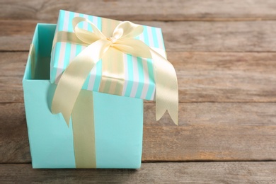 Photo of Elegant gift box with bow on wooden background