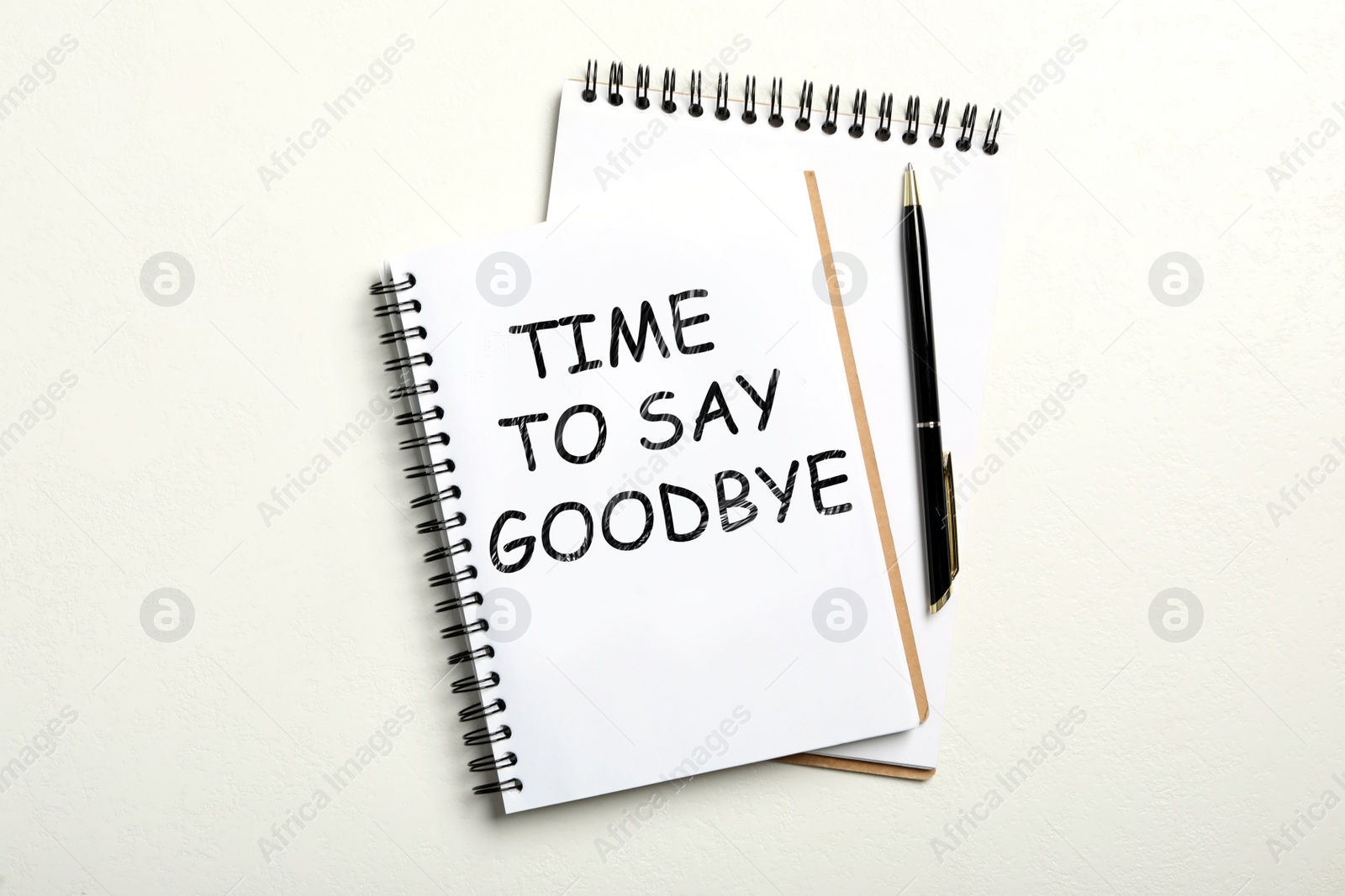 Image of Notebook with text Time to say goodbye on white background, flat lay