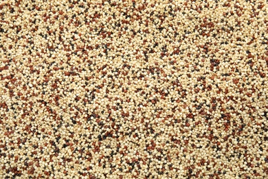 Photo of Mixed raw quinoa seeds as background, top view