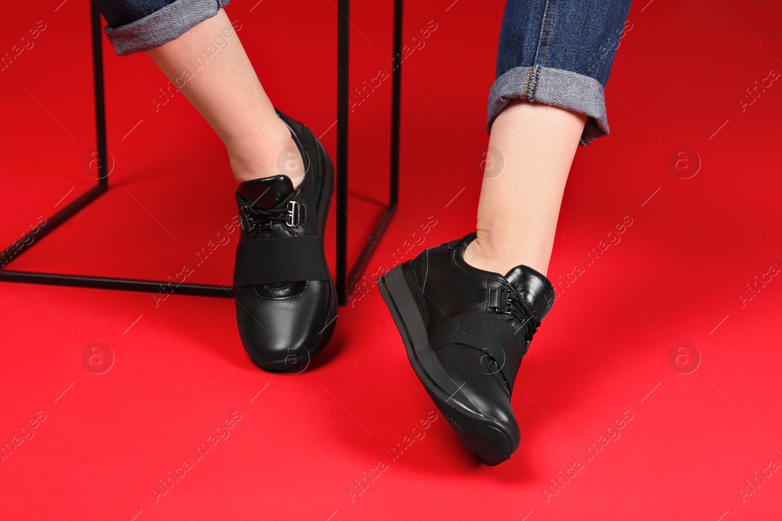 Photo of Woman in stylish sport shoes on color background