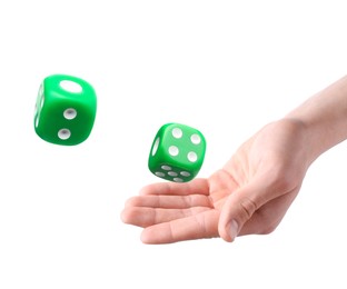 Man throwing green dice on white background, closeup