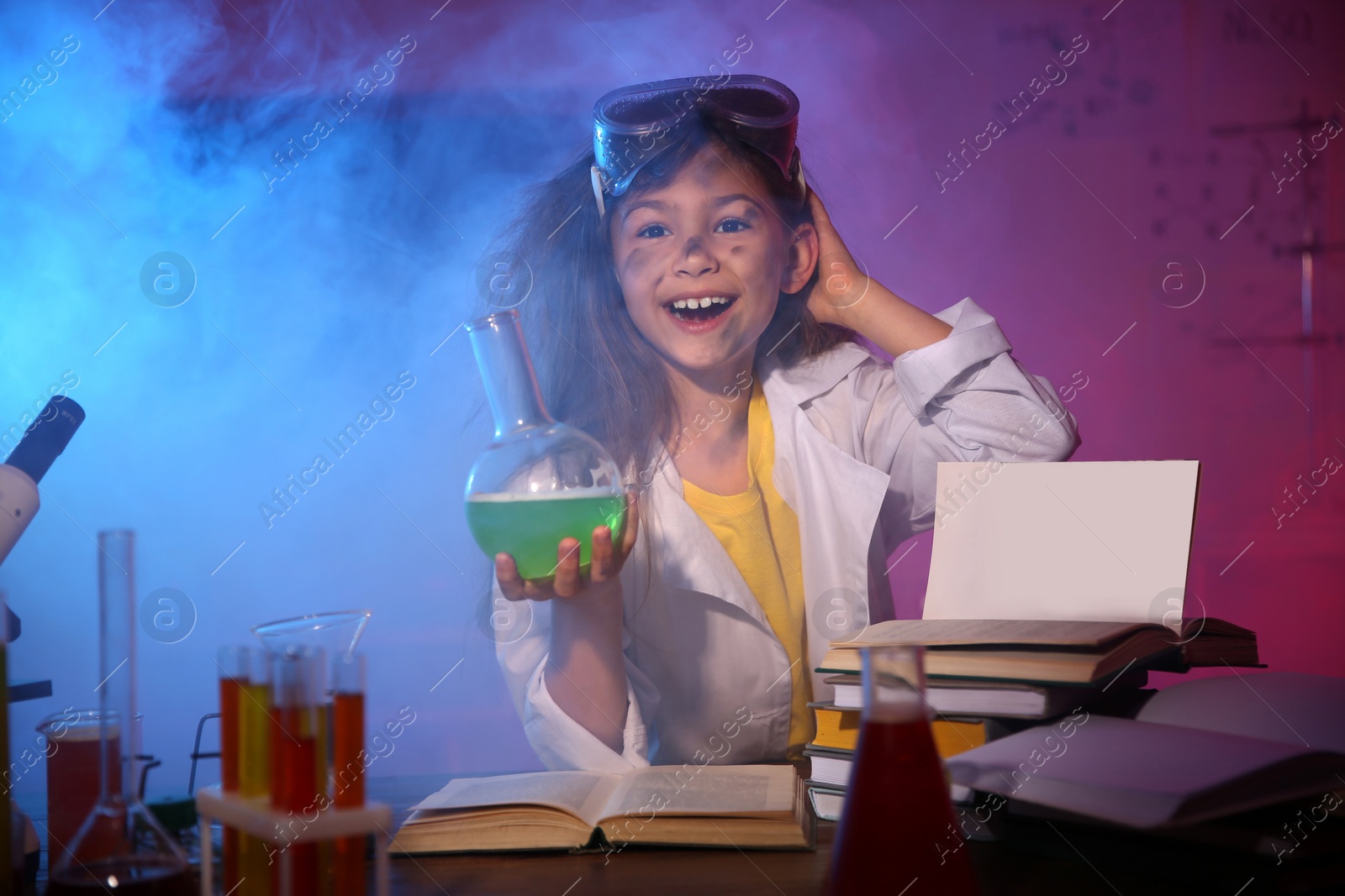 Photo of Child doing chemical research in laboratory. Dangerous experiment