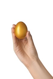 Woman holding golden egg on white background, closeup