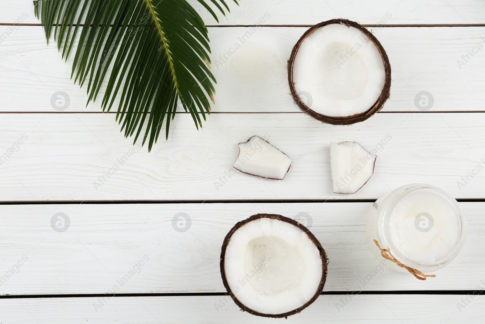 Photo of Flat lay composition with coconut oil on white wooden table. Cooking ingredients