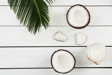 Flat lay composition with coconut oil on white wooden table. Cooking ingredients