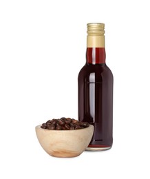 Photo of Bottle of delicious syrup for coffee and beans isolated on white