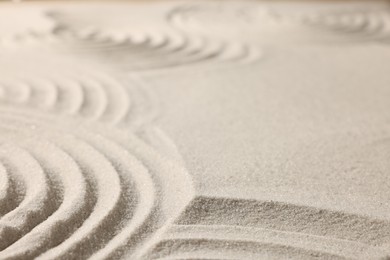Photo of Beautiful lines drawn on sand, closeup with space for text. Zen garden