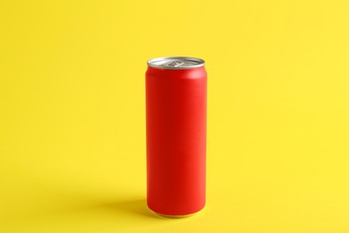 Photo of Energy drink in red can on yellow background