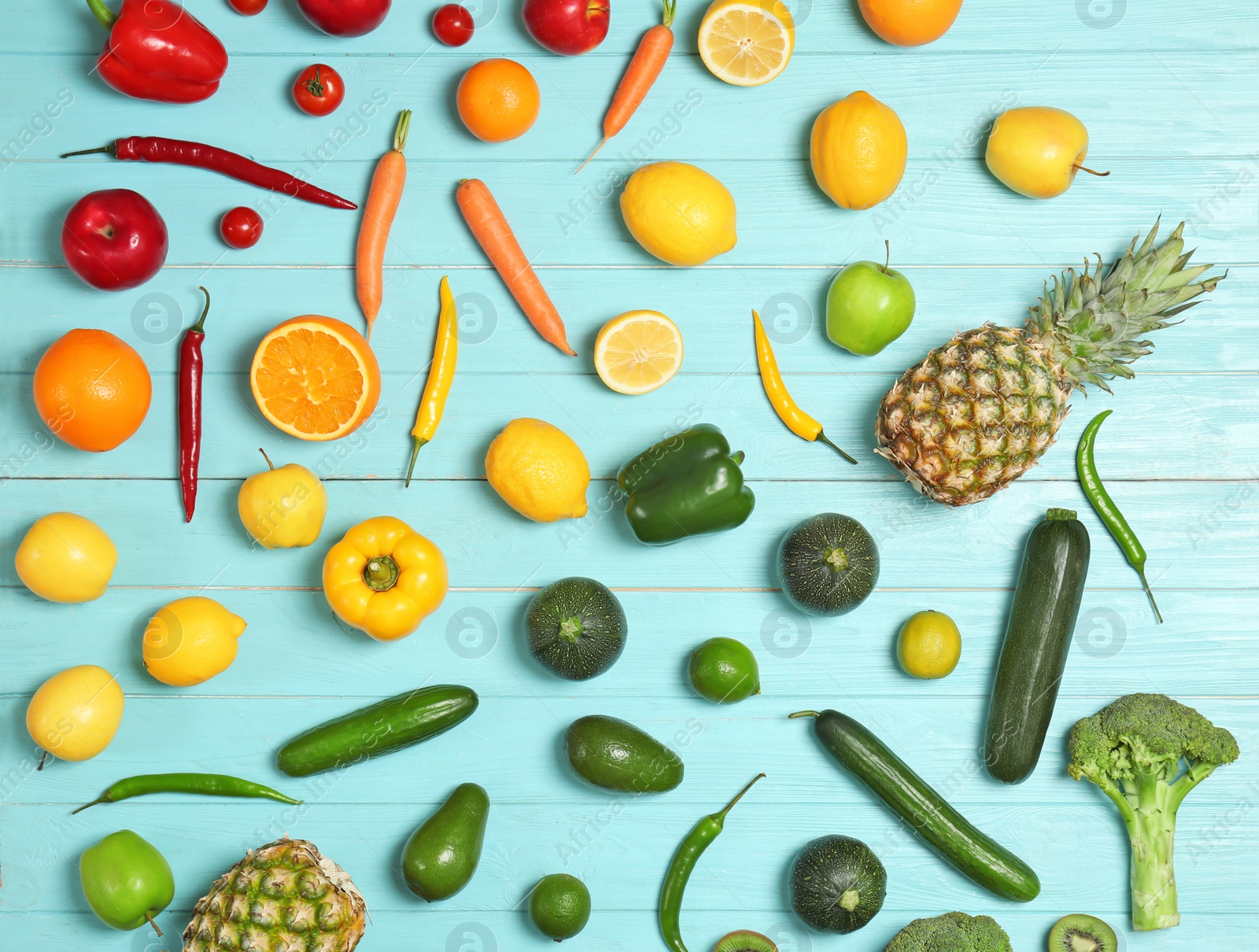 Photo of Rainbow collection of ripe fruits and vegetables on color background, top view