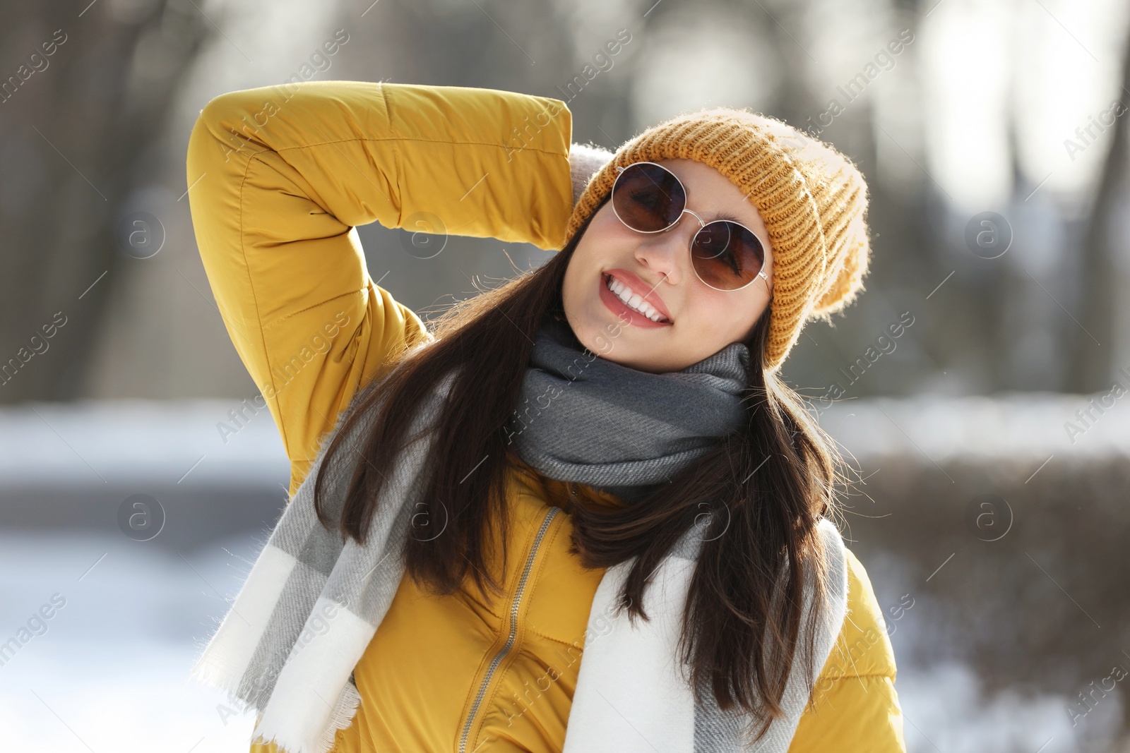 Photo of Portrait of beautiful young woman with sunglasses on winter day outdoors