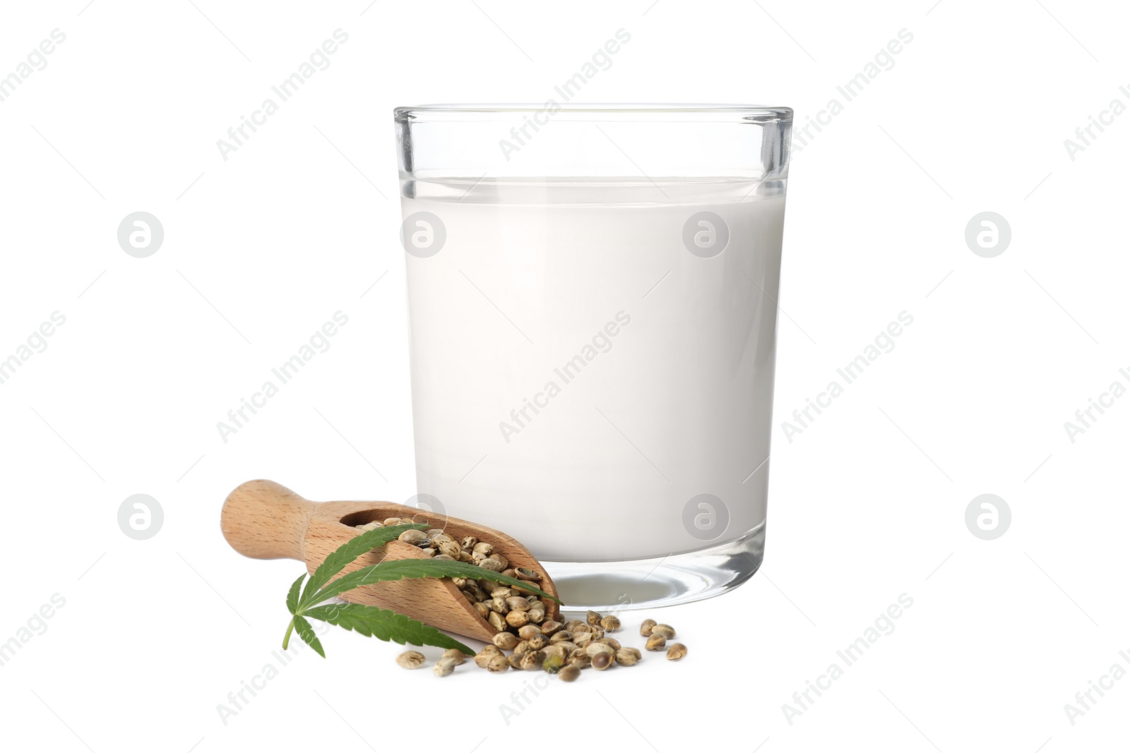 Photo of Glass of hemp milk, leaf and scoop with seeds on white background