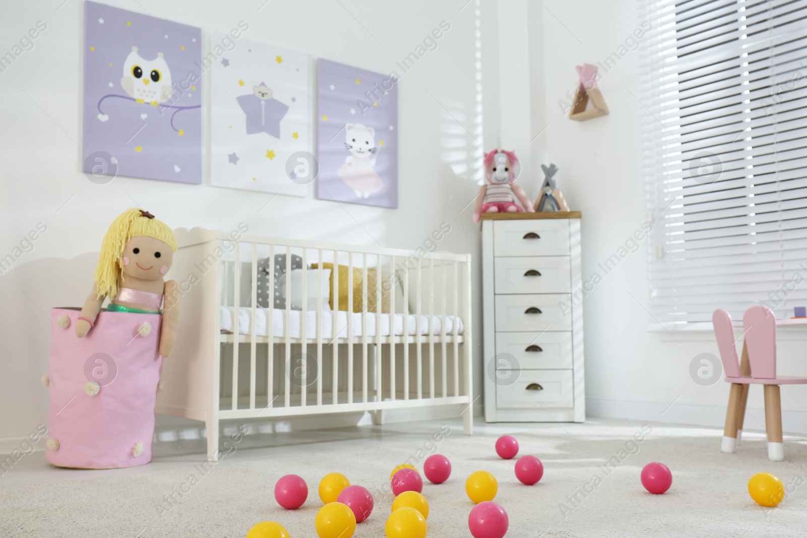 Photo of Baby room interior with cute posters and crib