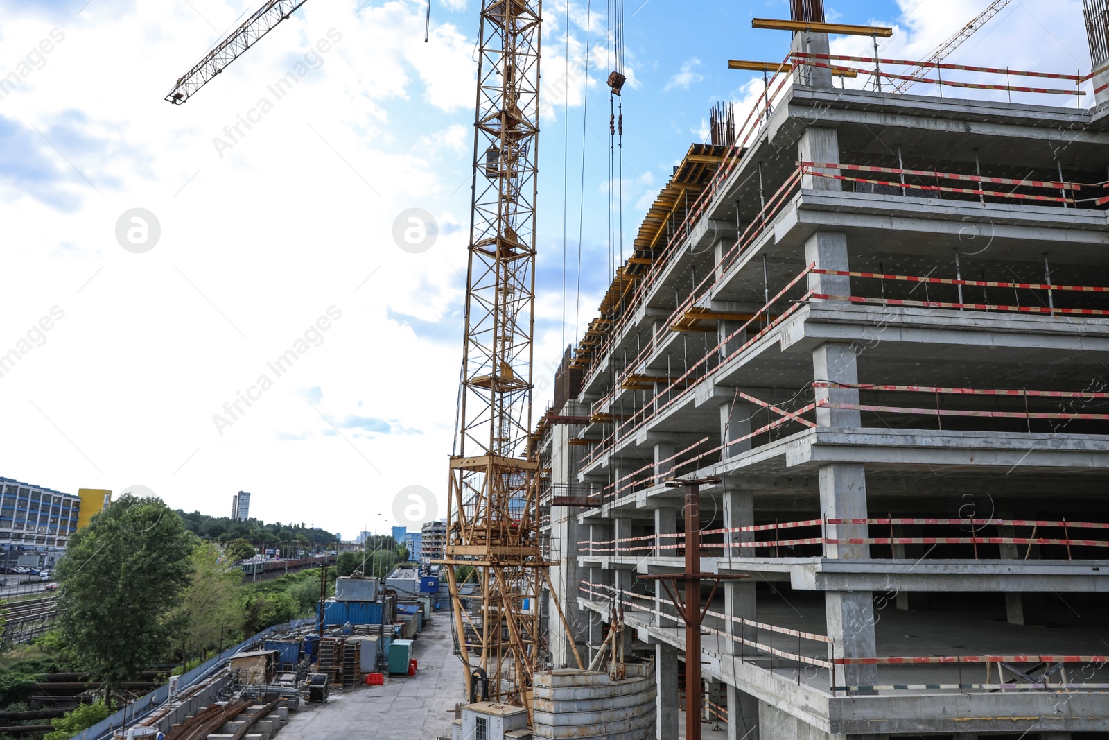 Photo of Unfinished building in city. Construction safety rules