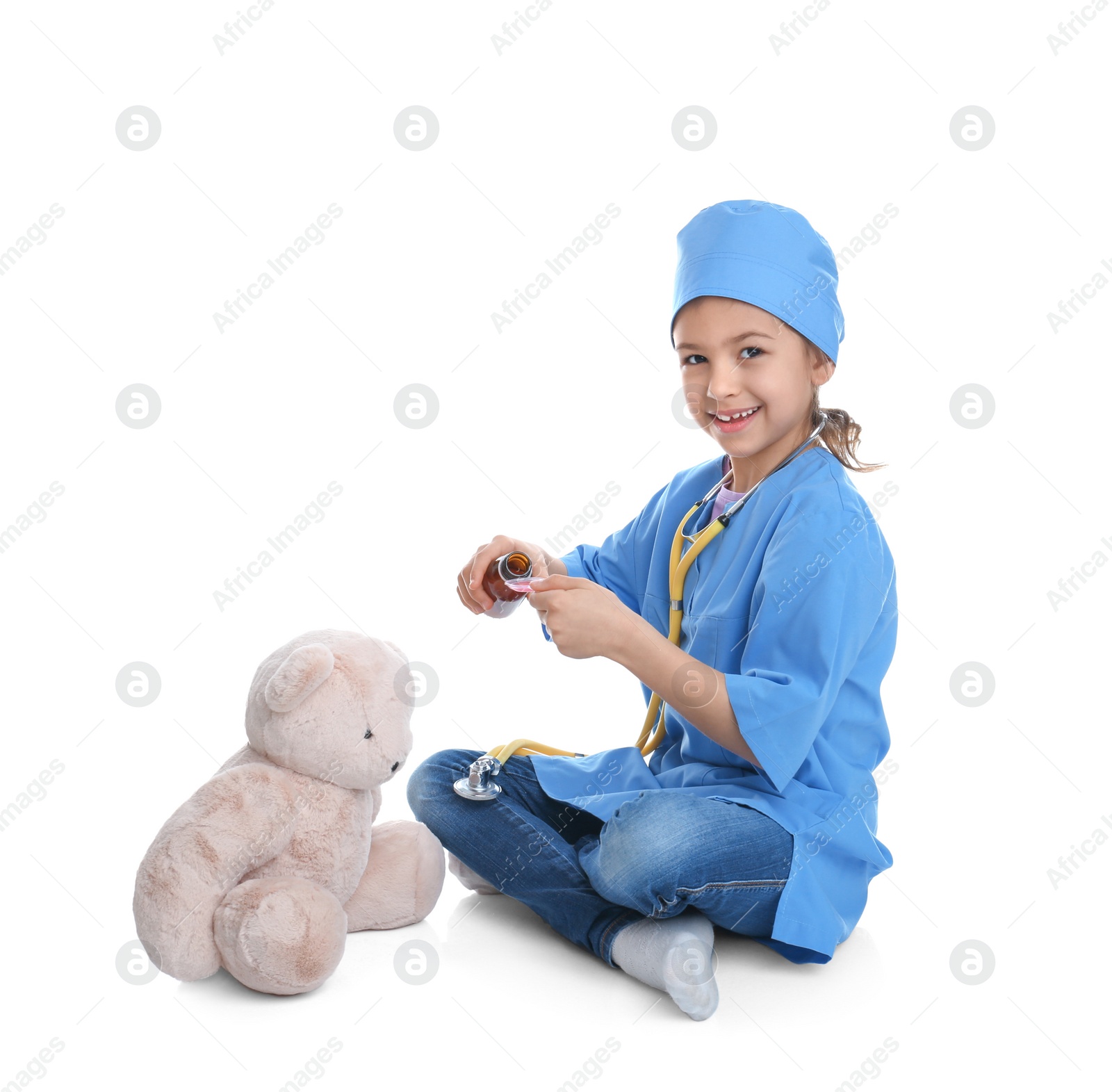 Photo of Cute child playing doctor with stuffed toy on white background