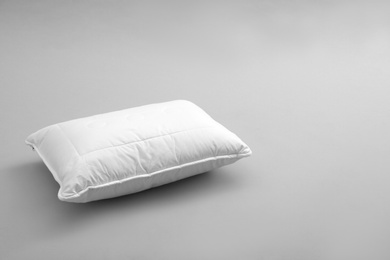 Photo of Clean soft bed pillow on grey background