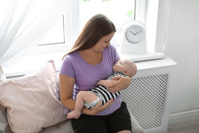 Mother with her sleeping baby at home