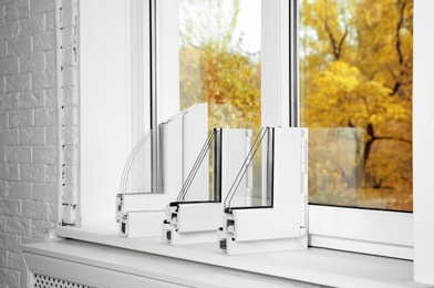 Samples of modern window profiles on sill indoors. Installation service