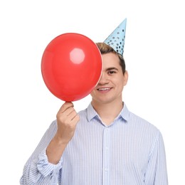 Photo of Young man with party hat and balloon on white background