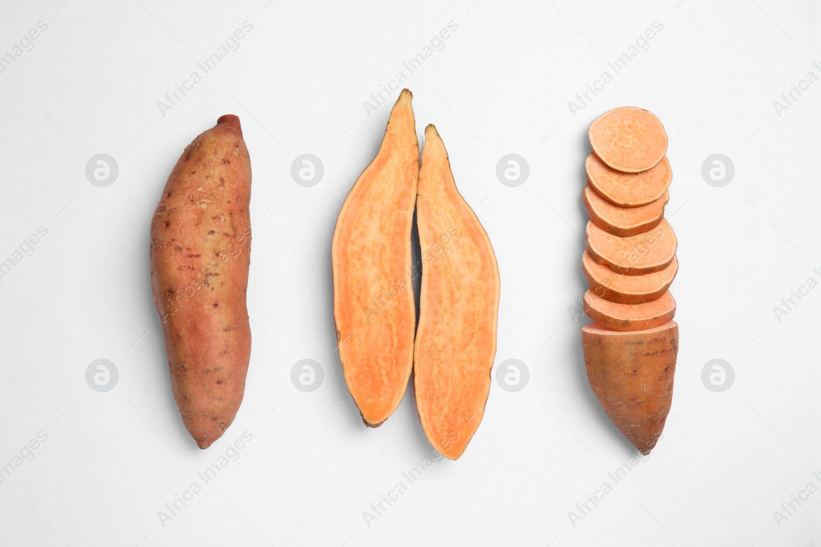 Photo of Cut and whole sweet potatoes on white background, top view