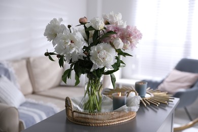 Photo of Bouquet of beautiful peony flowers on table indoors