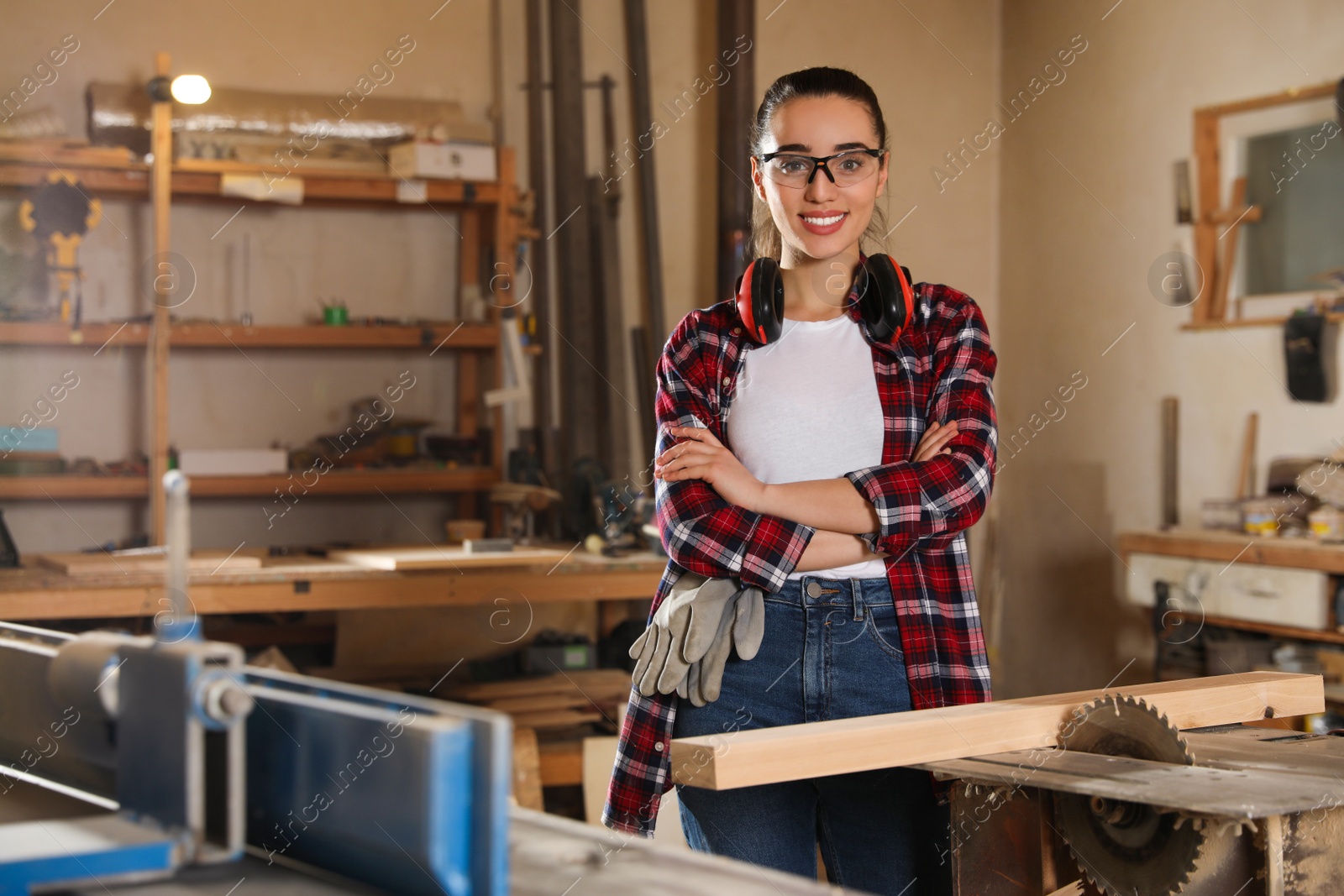 Photo of Professional carpenter near sawmill machine in workshop