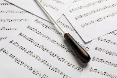 Photo of Conductor's baton on sheet music, closeup view