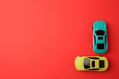 Photo of Different bright cars on red background, flat lay. Space for text