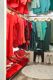 Photo of Different stylish clothes and shoes in dressing room. Fashion blogger