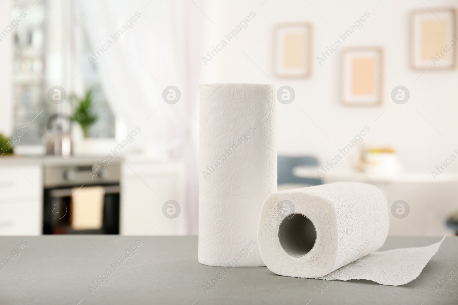 Photo of Rolls of paper towels on table in kitchen