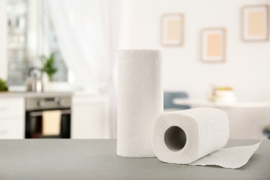 Rolls of paper towels on table in kitchen