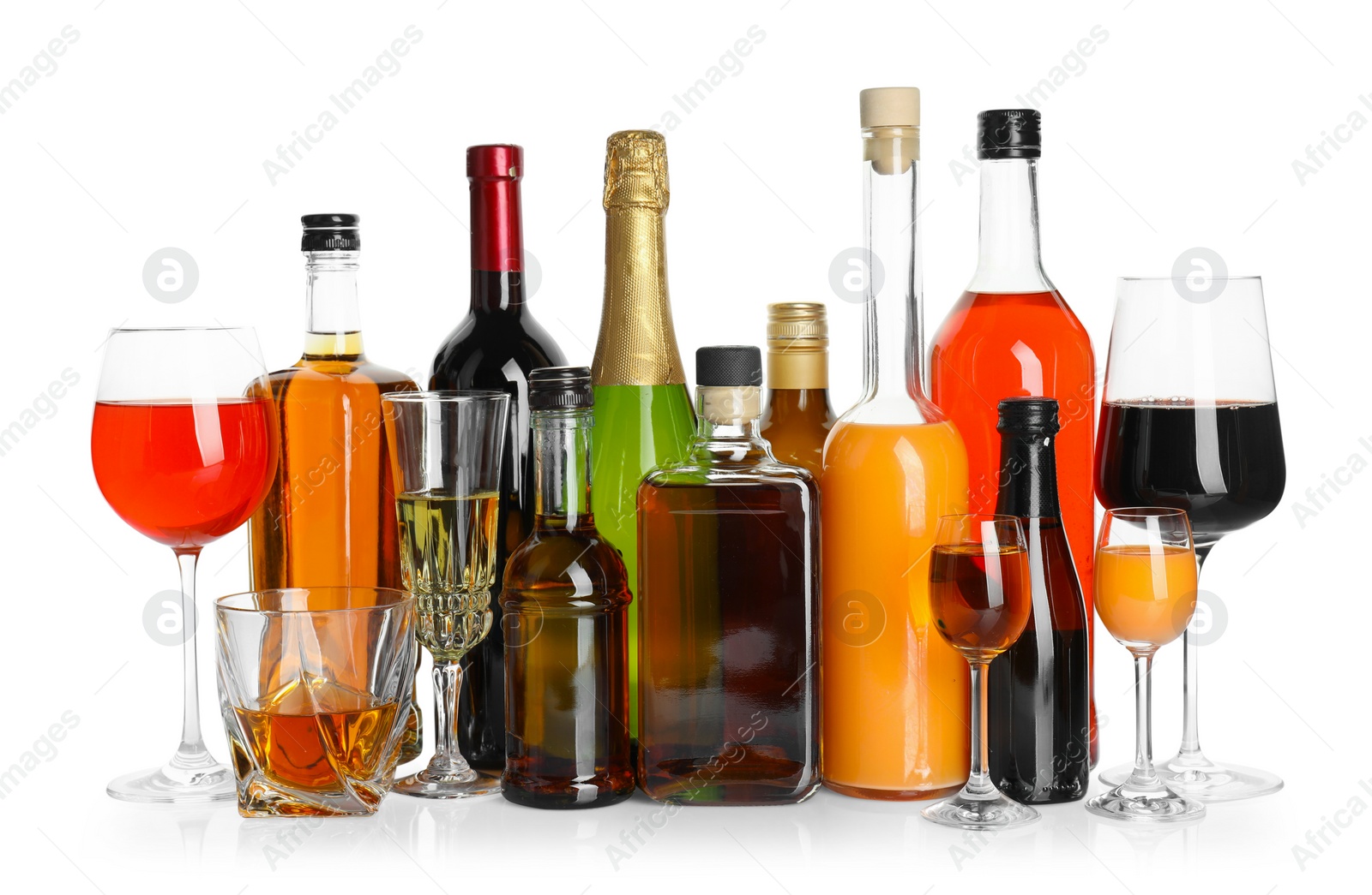 Photo of Bottles and glasses with different alcoholic drinks isolated on white