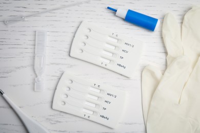 Photo of Disposable express test kit for hepatitis on white wooden table, flat lay