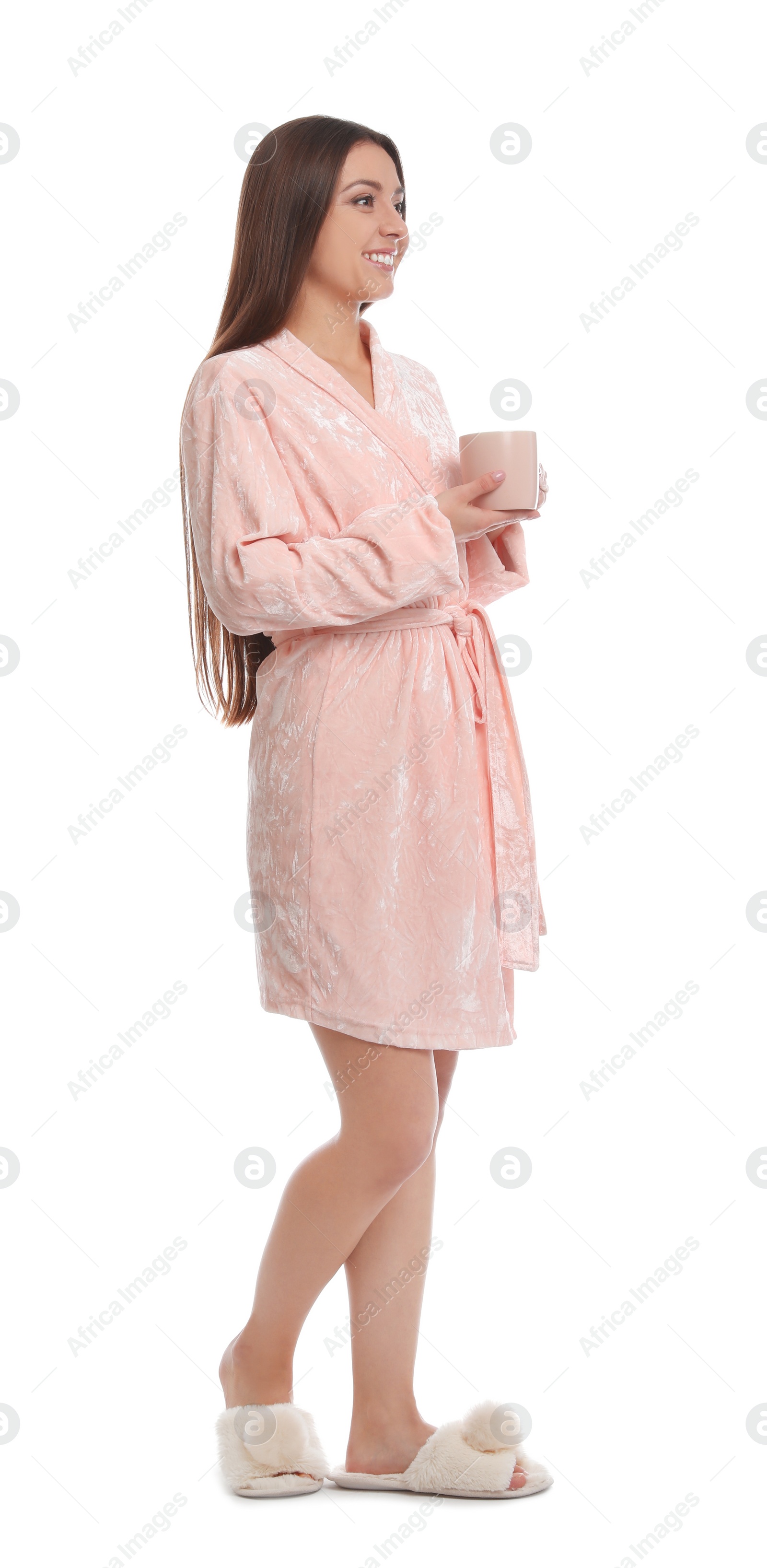 Photo of Young woman in bathrobe with cup of beverage on white background