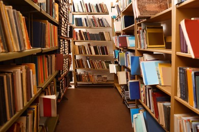 Collection of different books on shelves in library