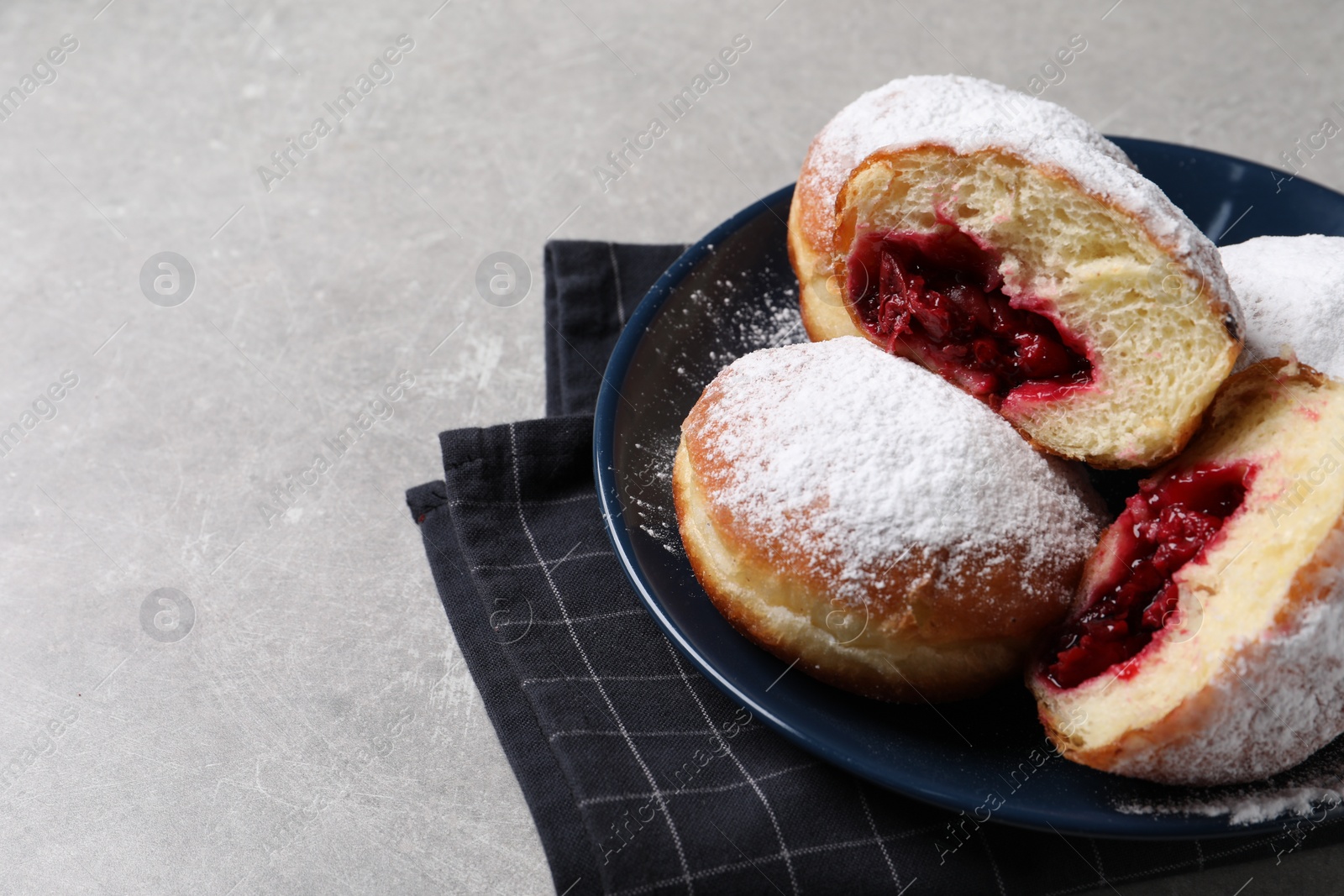 Photo of Delicious sweet buns with cherries on gray table, space for text