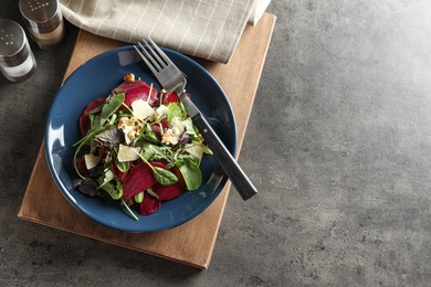 Plate with delicious beet salad on table, top view