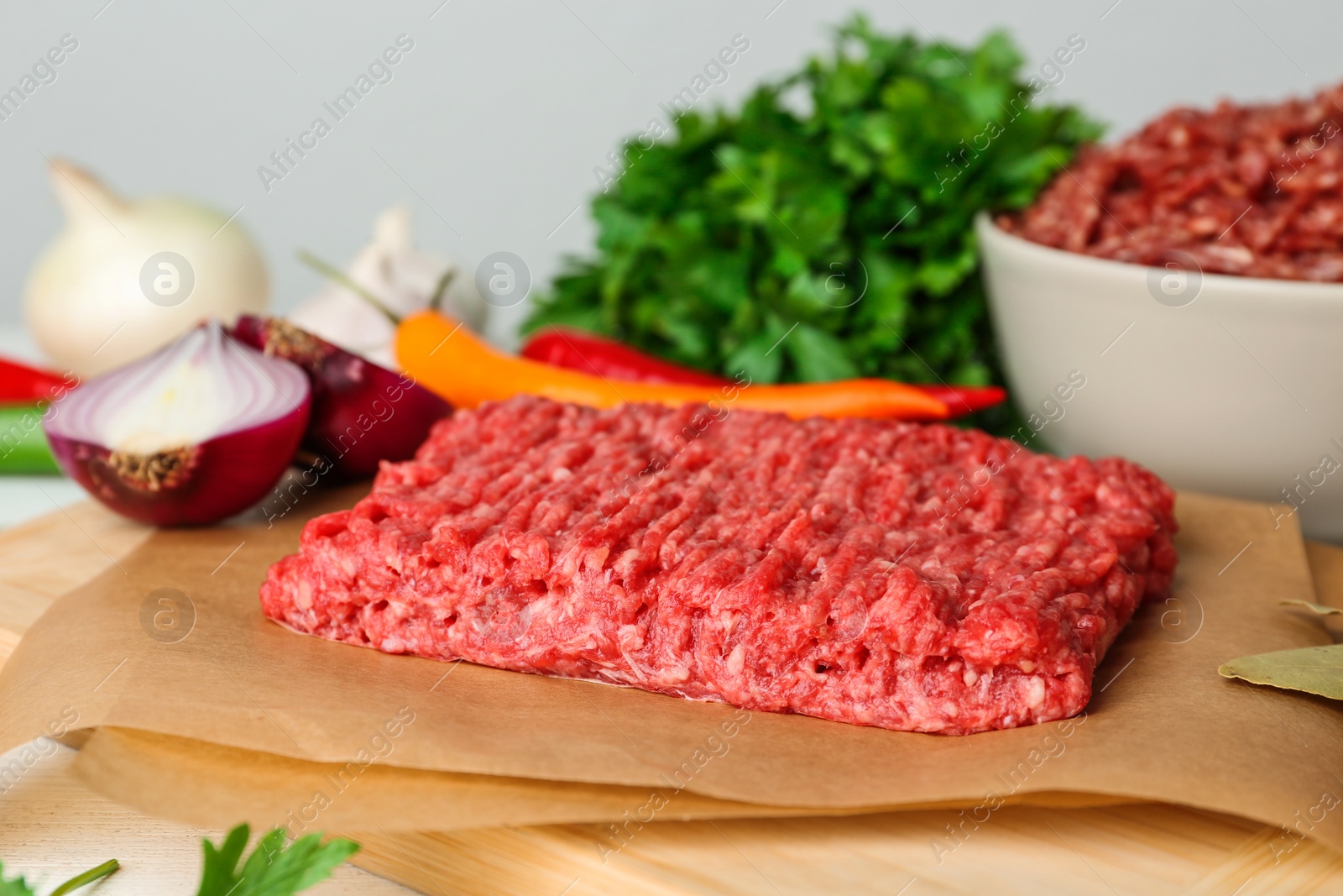 Photo of Fresh raw minced meat and vegetables on table