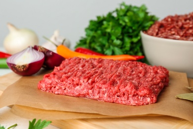 Fresh raw minced meat and vegetables on table