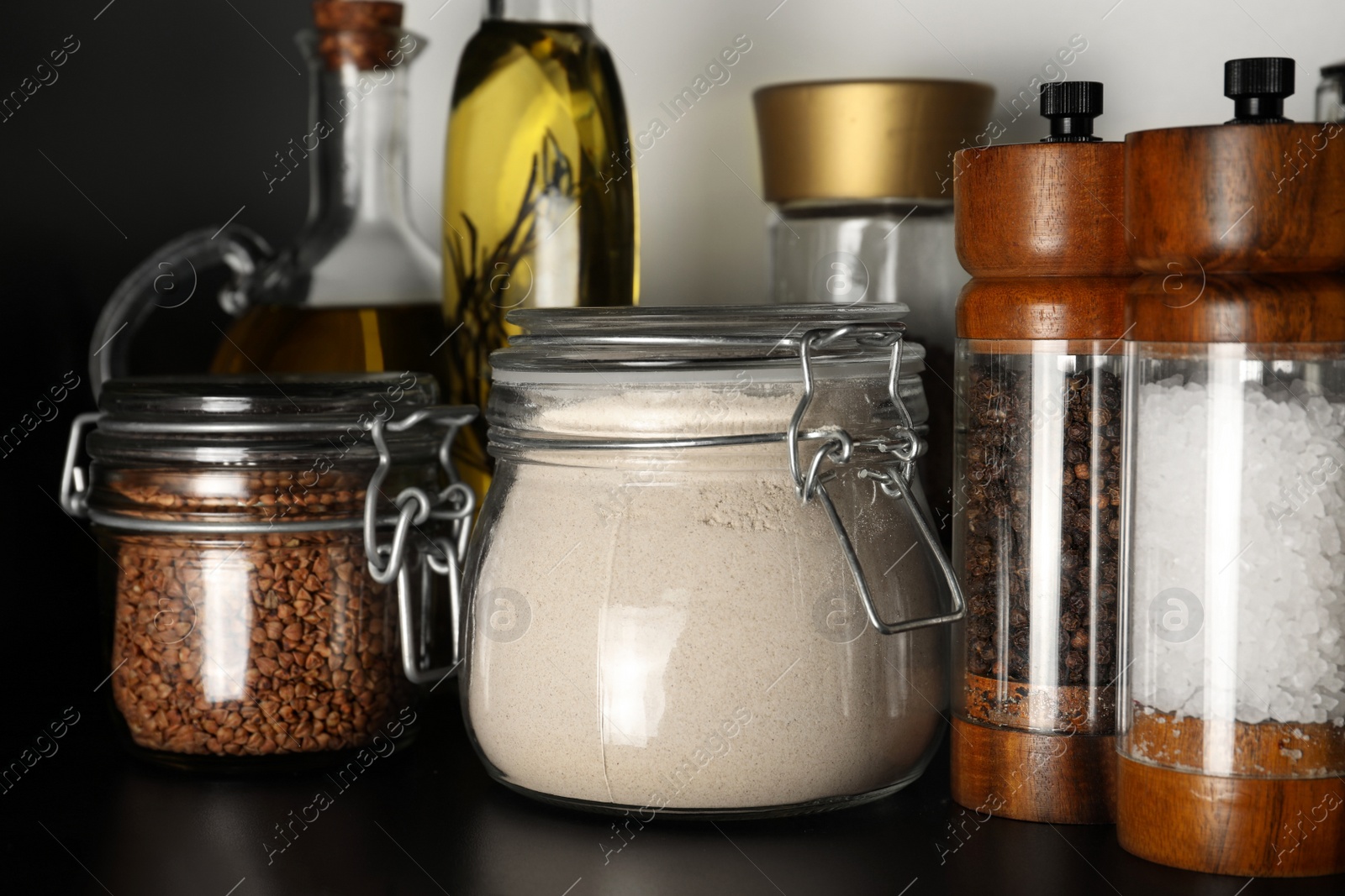 Photo of Flour and buckwheat in glass jars on shelf