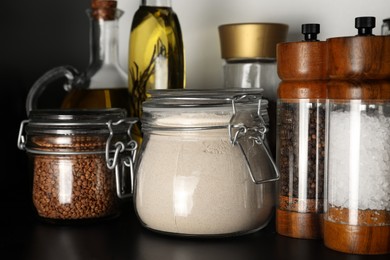 Photo of Flour and buckwheat in glass jars on shelf