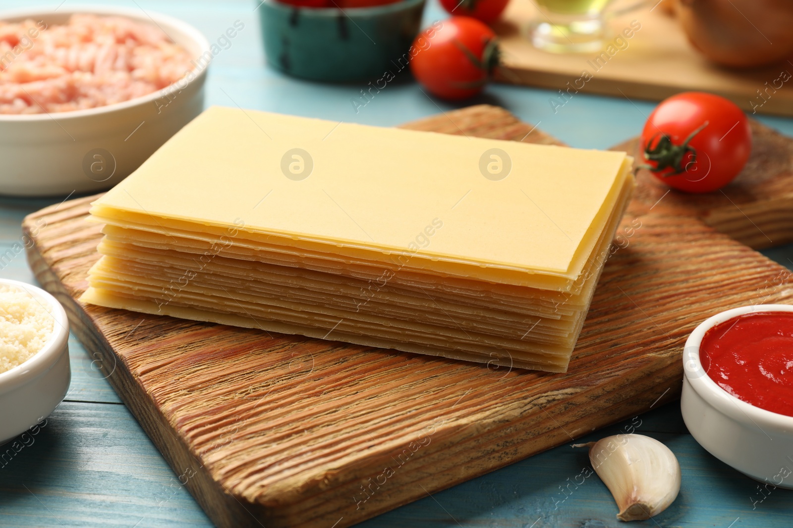 Photo of Ingredients for lasagna on blue wooden table, closeup