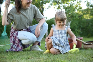 Mother and her daughter working together in garden