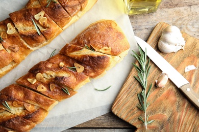 Flat lay composition with garlic bread on table