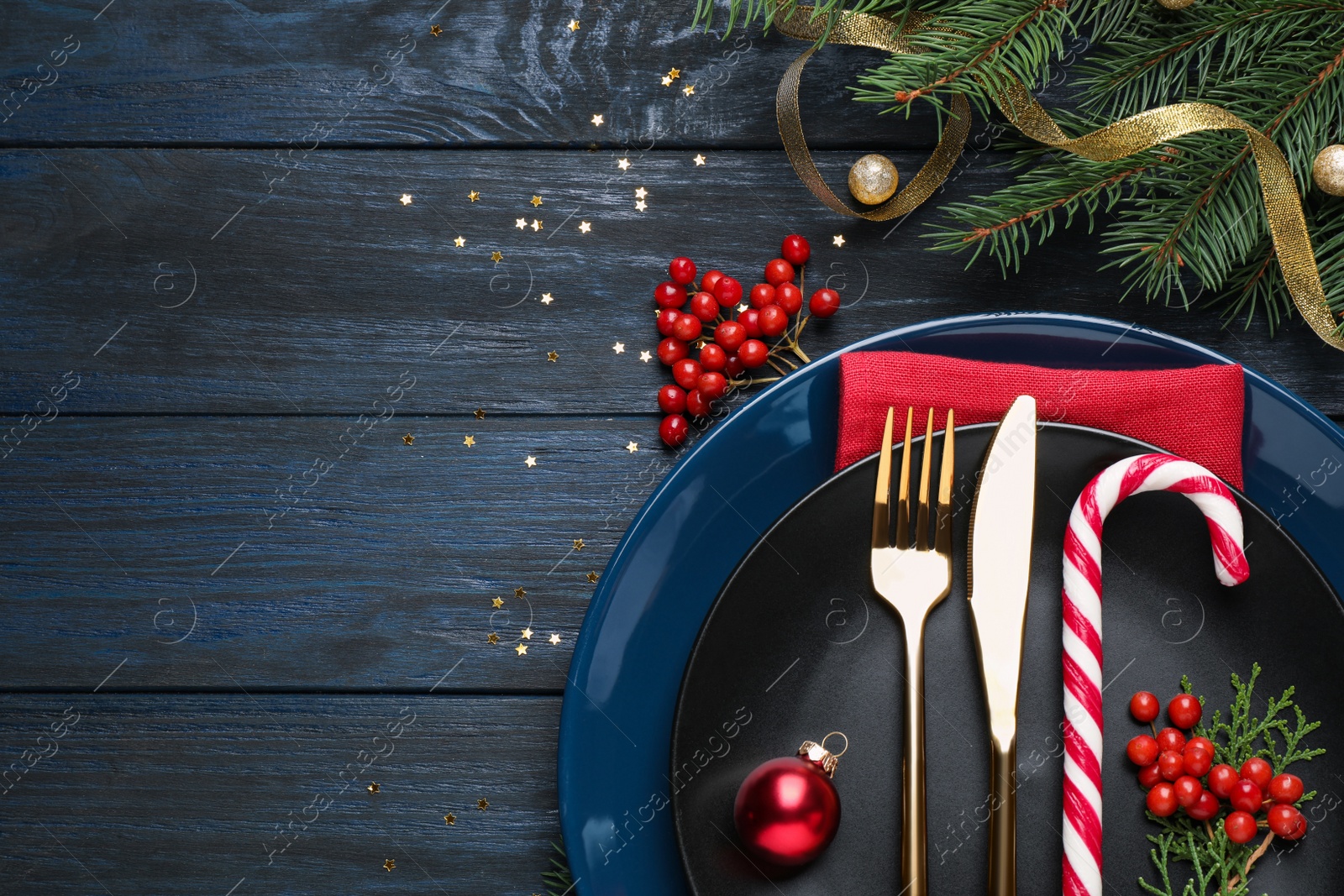 Photo of Beautiful Christmas table setting on dark wooden background, flat lay. Space for text