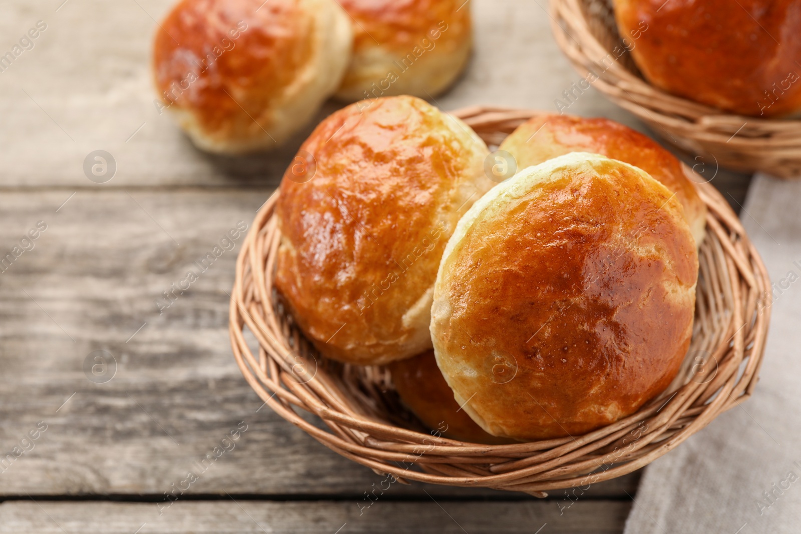 Photo of Freshly baked soda water scones on wooden table, closeup