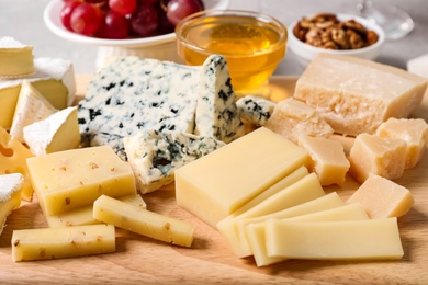 Photo of Plate with different sorts of cheese, closeup