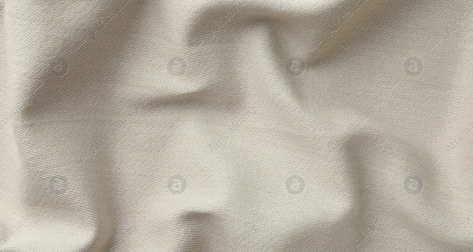 Photo of Texture of beige crumpled fabric as background, top view