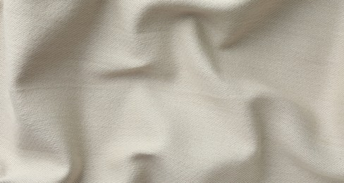 Texture of beige crumpled fabric as background, top view