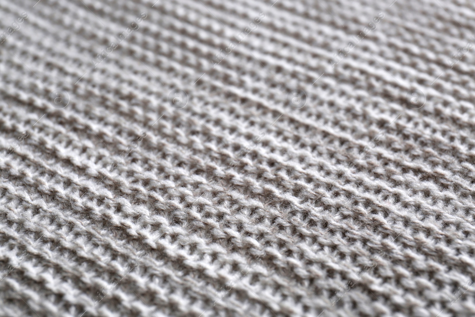 Photo of Beautiful grey knitted fabric as background, closeup