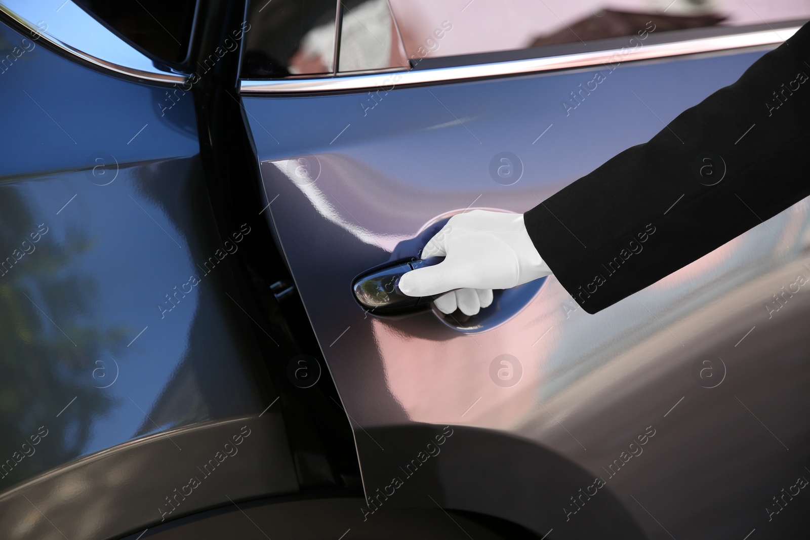 Photo of Driver opening car door, closeup. Chauffeur service